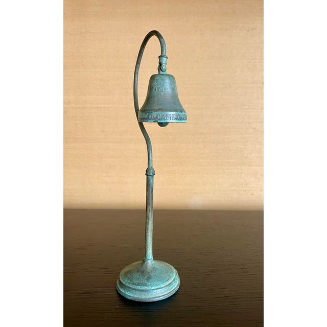 A beautifully patinated El Camino Real mission bell, cast as a desktop-scale commemorative of the iconic bells that line...