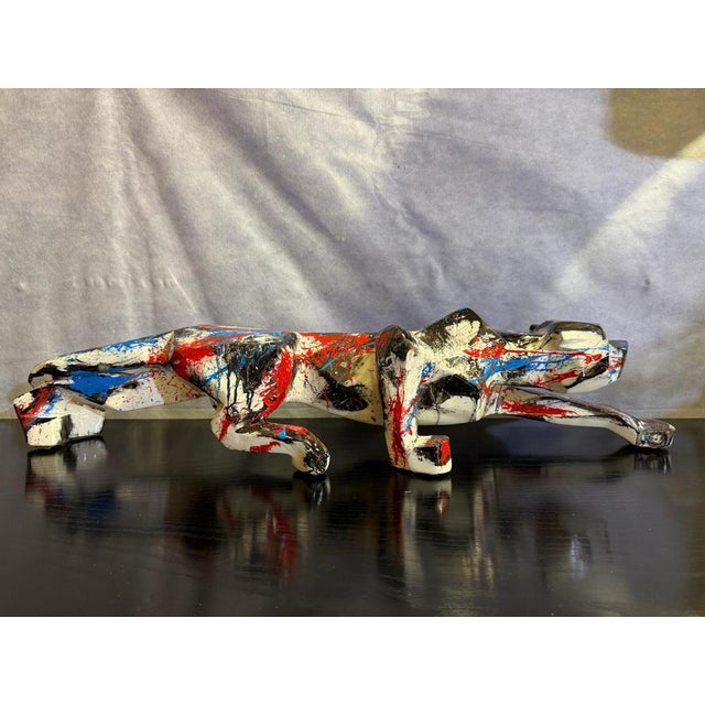 Resin panther painted by artist Silvio Formichetti in the colors of red, blue, white and black. This piece has an...