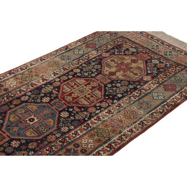 Hand-knotted in wool and originating from turkey circa 1950-1960, this 3x14 vintage runner rug features a design that...