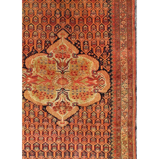 Antique Mission Malayer Rug with Floral Medallion in Blue, Orange & Green. This amazing, antique mission Malayer rug was...