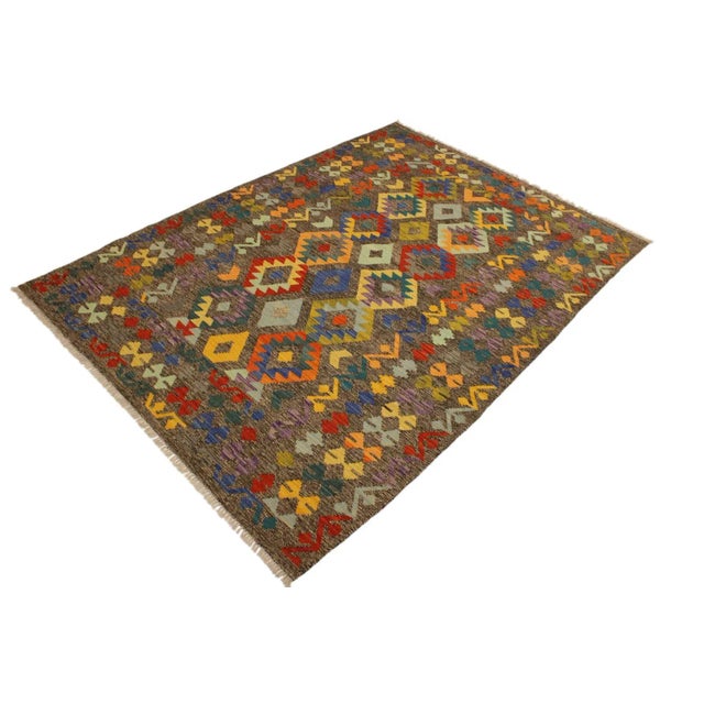 Add a touch of elegance to your home with this casual chic hand woven Tribal Kilim wool rug. Constructed on a loom by...