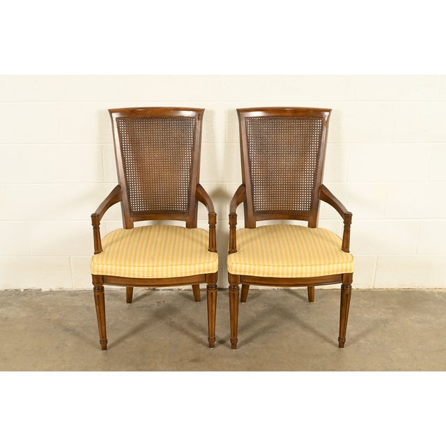 A gorgeous pair of French Regency Louis XVI style armchairs or dining captain chairs By Henredon USA, Circa 1970s Carved...