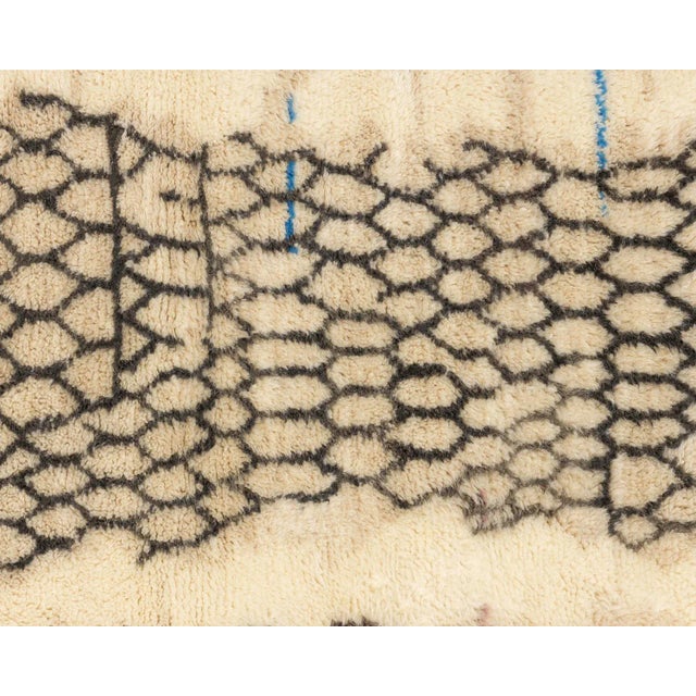 Exquisite hand-knotted wool rug featuring a unique Honeycomb pattern in Charcoal and Ivory, accented with subtle Sky Blue...