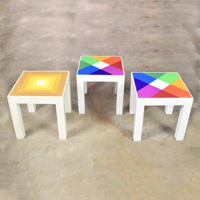 Amazing trio of mod pop art plastic parsons style square side tables in the style of Kartell or Syroco. With one table...
