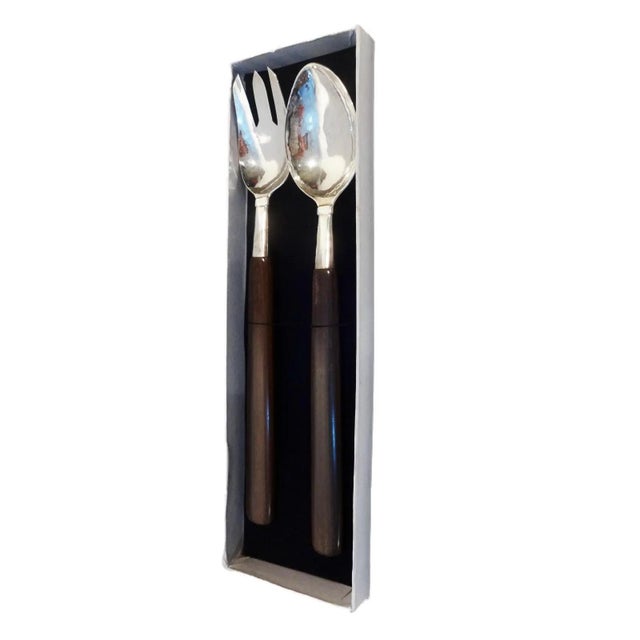 An elegant vintage sterling silver salad service comprising an unused spoon and fork, each fitted with refined rosewood...