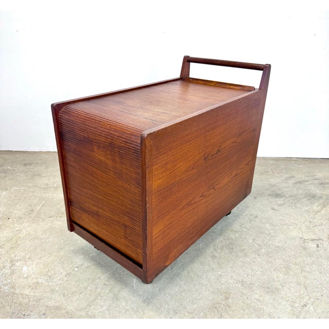 A rare teak art, craft or sewing cart with tambour door, divided top tray, 2 removable work trays and plenty of storage....