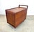 A rare teak art, craft or sewing cart with tambour door, divided top tray, 2 removable work trays and plenty of storage....