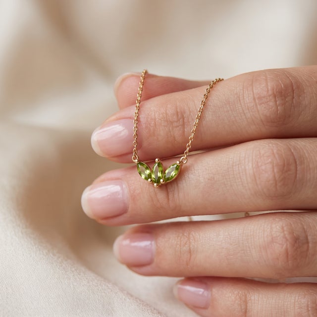 Add a touch of vibrant freshness to your jewelry collection with this romantic three-stone pendant necklace, featuring...