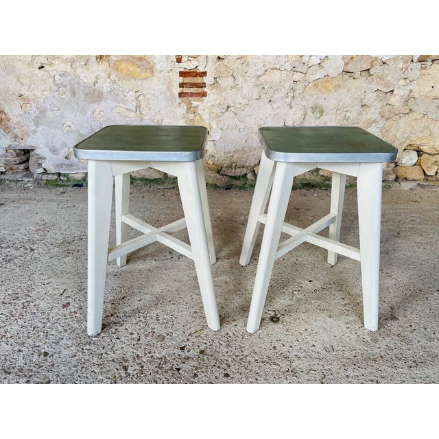 Vintage, low stool made of wood, with a vinyl seat surrounded with brushed metal trim, circa 1960's. - there are two...