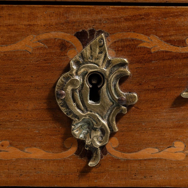 Carved walnut petite commode in Rich Walnut Brown. The rich walnut brown surface highlights ornate ormolu mounts, cabriole...
