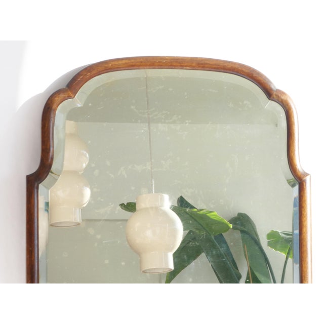 A large antique wooden scalloped mirror with beveled glass. The frame is made out of solid wood and has a nice curved...
