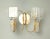 Italian wall lights with clear faceted glass diffusers mounted on circular golden structures / Made in Italy, circa 1960s...
