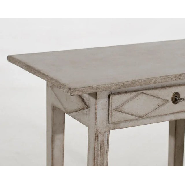 This antique swedish table circa 1790 provides unique charm. Its one drawer features intricate carvings. H. 75 w. 83 d. 48...