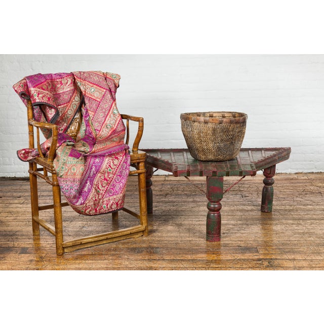 An antique rustic green and red painted coffee table crafted from a repurposed bullock cart from the 19th century with...