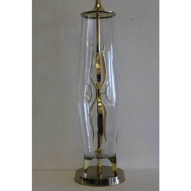 Brass and glass lamp attributed to the Laurel Lamp Co. Consists of glass containing a brass sculpture. Measures: Total...