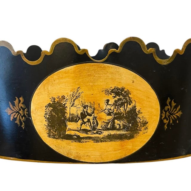 A charming, vintage Italian cache pot. Features a scalloped, Monteith style oval body in a black with gilt details....