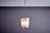 Elegant Italian suspension lamp from the 1950s, featuring a brass frame and curved glass diffuser with sandblasted...