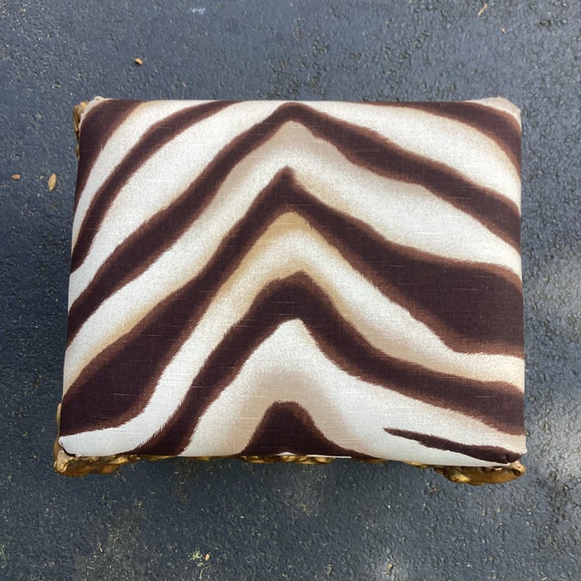 Striking Hollywood Regency–style giltwood stool featuring dramatic hand-carved figural legs terminating in paw feet, each...