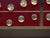 Italian burgundy sideboard with a birch-wood structure, brass framing and 28 circular Murano glass accents. Its...