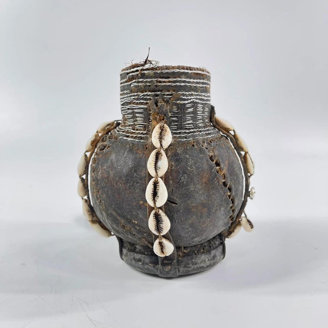 This early 20th-century Ethiopian milk jug exemplifies the artistry and craftsmanship of traditional pastoral communities...