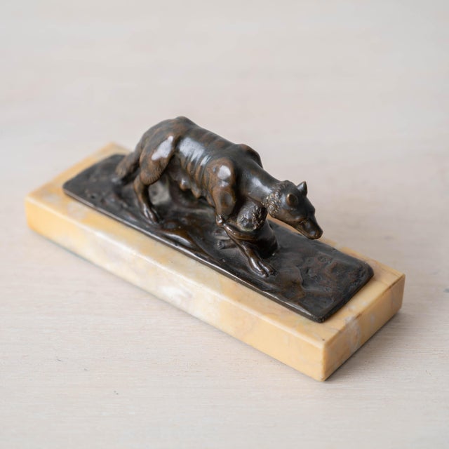 Bronze figure of the Capitoline She-Wolf (Lupa Capitolina) suckling Romulus and Remus on rocky base with polished honey...