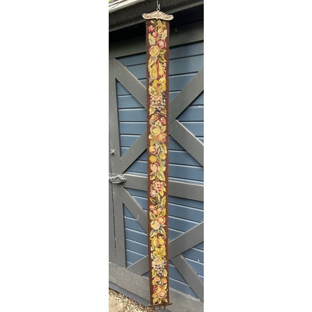 A hand stitched needle point bell pull, with beautifully detailed ends and floral motif.