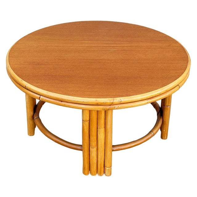 This beautifully restored Mid-century round Rattan coffee table features unique five-pole rattan legs with wicker...