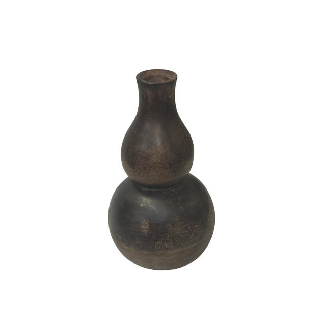 This hand-carved wooden vase is crafted in a classic double-gourd silhouette, a traditional form symbolizing longevity and...