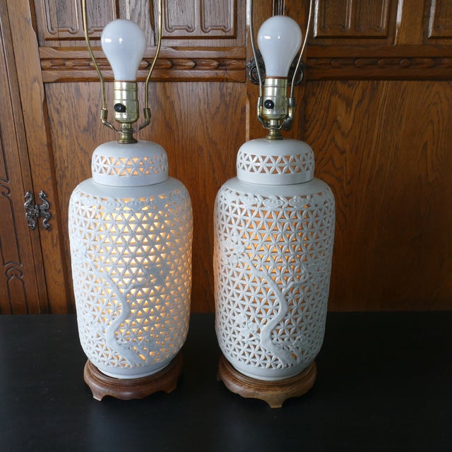Fabulous pair of vintage Chinoiserie Blanc de chine large sized table lamps. Set on wood bases, they measure 19" to the...