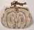 This is a very pretty antique evening bag of cream colored seed pearl-sized glass beads with a pattern of paisleys and...