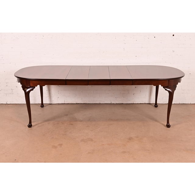 An exceptional Queen Anne or Georgian style solid mahogany extension dining table By Henkel Harris USA, Circa 1970s...