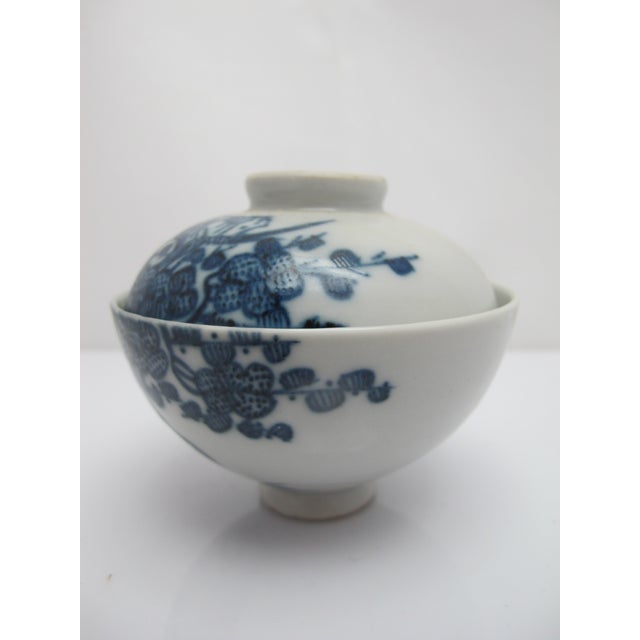 Small Japanese sometsuke style porcelain lidded rice or soup bowl. White with intricate blue flowering branches. Excellent...