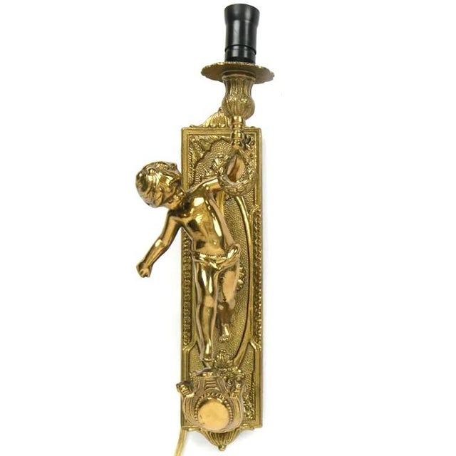 A delightful pair (2) of Italian brass cherubic lighting sconces. The pair of cherubs is solid brass and is very well...