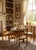 A charming set of four antique English pine children's chairs, hand-sourced in the United Kingdom and brought to you...