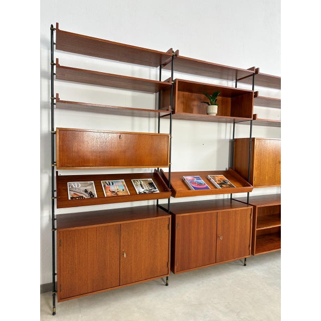 Beautiful vintage freestanding shelving system original form the 1960s made of black metal ladders and teak wood elements....