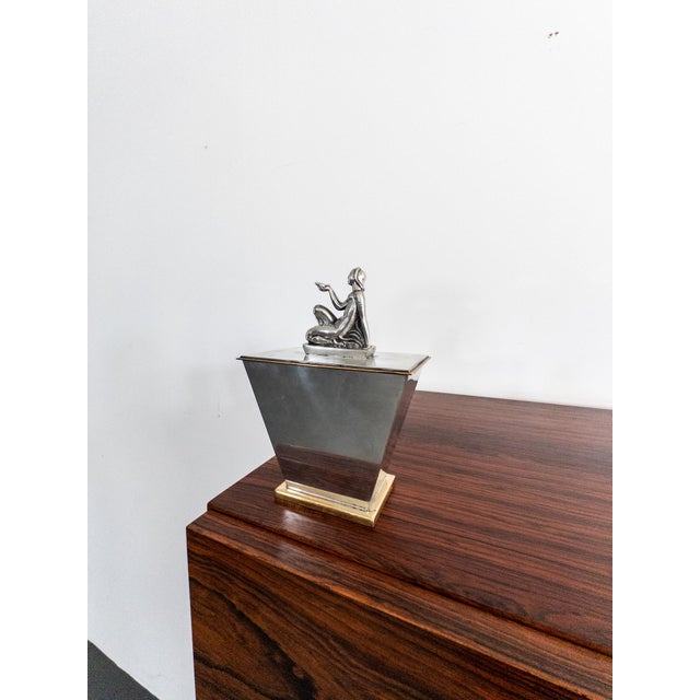 This exquisite lidded box from Ystad Metall, designed by the renowned Swedish sculptor Oscar Antonsson, is a true Art Deco...