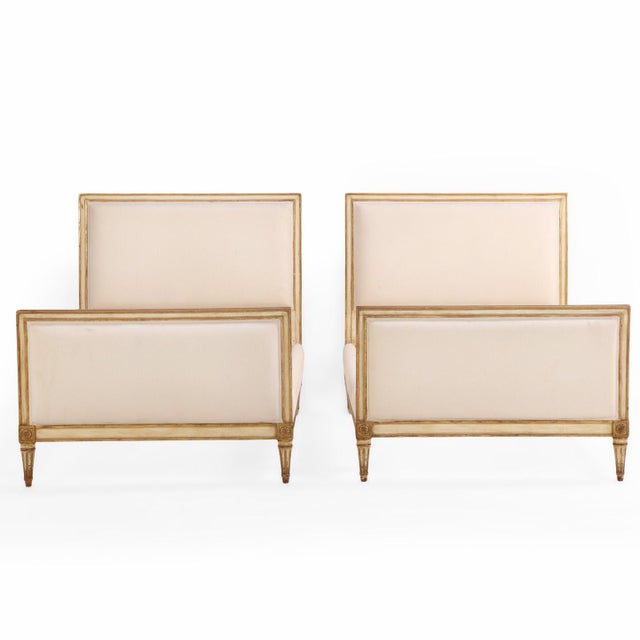 The frames feature refined square head and footboards highlighted with giltwood accents, adding an elegance to the clean,...