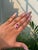 This elegant 3.16 carat emerald-cut ruby and diamond bypass ring is crafted in 14K yellow gold. Each ruby measures...