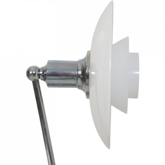 Poul Henningsen 2/1 wall lamp with a chrome frame and white opal glass shades. The lamp is from the 2010s and appears in...