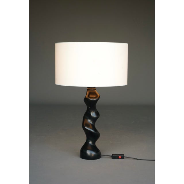 Beautiful mid-century lamp crafted from solid wood into an organic softly twisted form.This elegant lamp has a strong...
