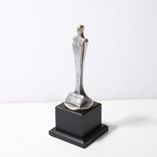 A remarkable Art Deco prototype Oscar sculpture, signed E. W. Lane, American, circa 1935. This stunning piece represents...