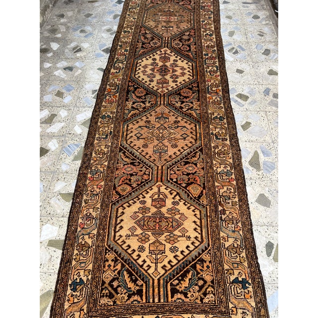 Persian Bibikabad design hand-knotted runner featuring stacked hexagonal lozenge medallions in warm camel and cream tones,...