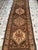 Persian Bibikabad design hand-knotted runner featuring stacked hexagonal lozenge medallions in warm camel and cream tones,...