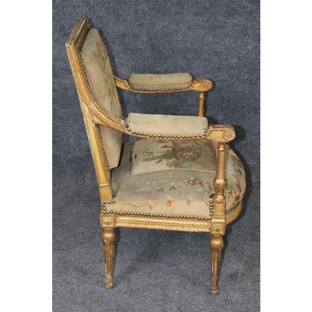 This exquisite late 19th- to early 20th-century French Louis XVI-style armchair is a beautiful example of classical French...