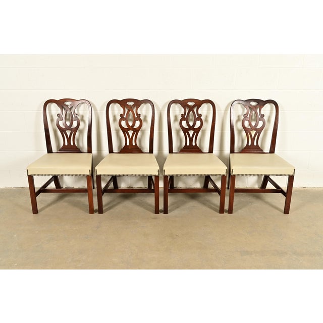 An outstanding set of four Georgian or Chippendale style dining chairs By Baker Furniture USA, Circa 1980s Carved solid...