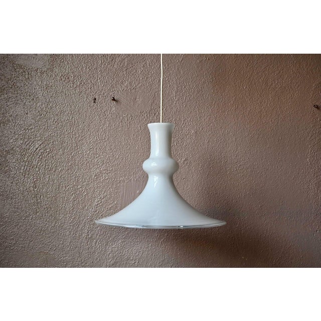 Refined and timeless, this beautiful Danish pendant light is the brainchild of the talented Michael Bang. Made of white...