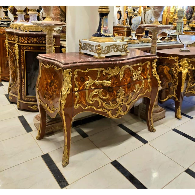 A true masterpiece of French-inspired luxury, this stunning Louis XV Bombe Commode showcases an elegant serpentine...