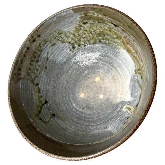 A large ceramic bowl by Japanese American artist Toshiko Takaezu (American, 1922 - 2011). The deep form bowl features a...