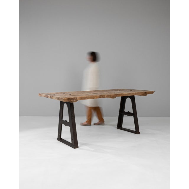 This Early 20th Century French Industrial Table is a splendid representation of utilitarian design fused with rustic...