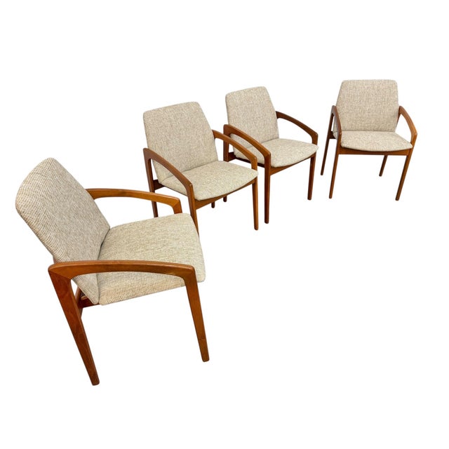 Elevate your dining space with this stunning set of four Mid-Century Modern Danish teak dining chairs. Showcasing the...